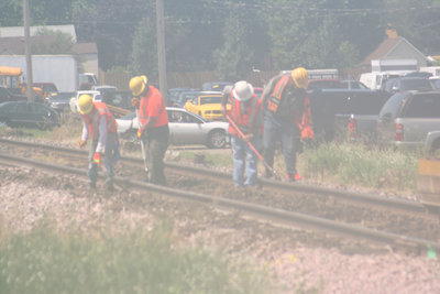 It was so muggy Monday, the camera couldn t get a clear shot of these Union Pacific Railroad laborers replacing wooden ties downtown. 